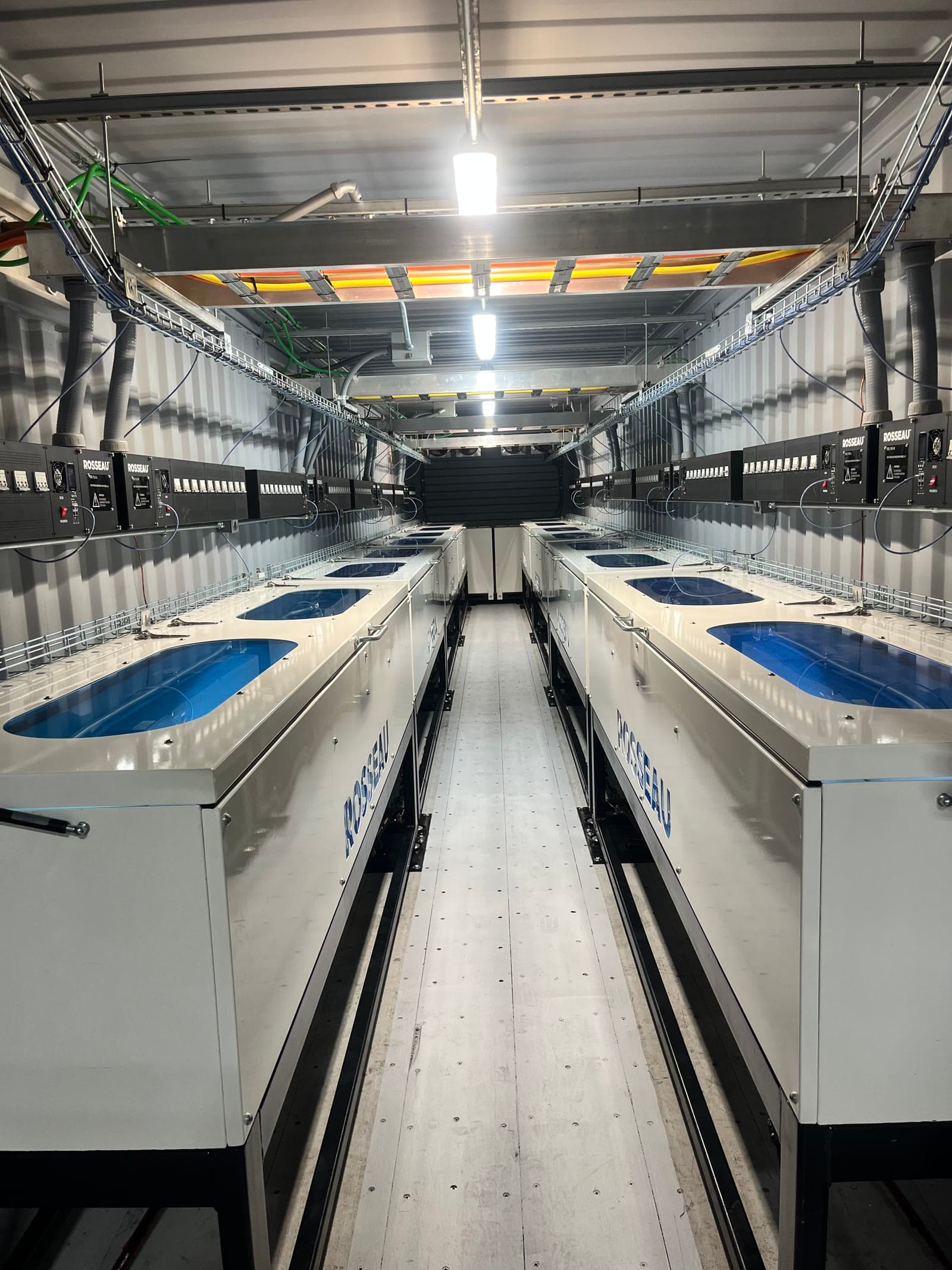 Interior aisle view of immersion-cooled container system